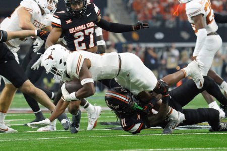 Photo for December 2, 2023, Arlington, Texas, United States: Oklahoma State Cowboys safety Dylan Smith tackles a Texas Longhorns  player during the 2023 Dr Pepper Big 12 Championship game between Texas Longhorns  and Oklahoma State Cowboys - Royalty Free Image
