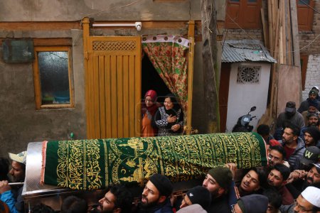 Photo for December 08,2023, Srinagar Kashmir, India : Kashmiris carry the coffin containing the body of slain Indian police Inspector Masroor Ahmad Wani during his funeral procession in Srinagar - Royalty Free Image