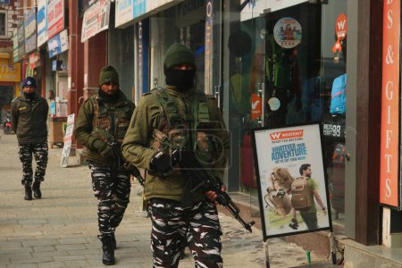 Photo for December 11,2023, Srinagar Kashmir, India : Indian paramilitary soldiers patrol along a road in Srinagar. India's Supreme Court upheld the abrogation of the Jammu and Kashmir special status in its verdict on 11 December - Royalty Free Image