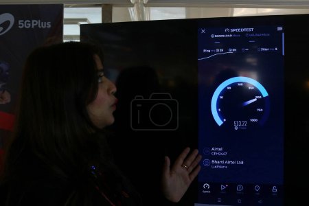 Photo for December 12,2023, Srinagar Kashmir, India : A woman member of Bharti Airtel shows the 5G plus speed during live 5G plus experience in Srinagar. Airtel announced the launch of its cutting edge 5G services - Royalty Free Image