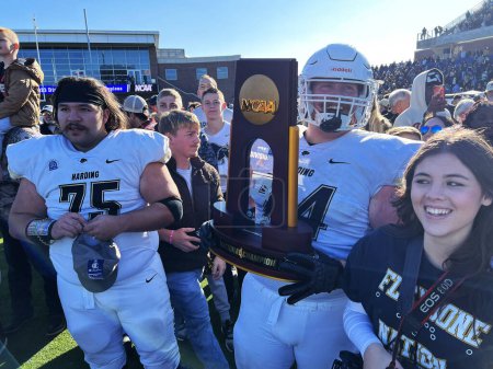 Photo for McKinney, Texas, United States: Harding University's offensive lineman Hunter Willis holds the NCAA Division II Football Champion trophy after his team defeated Colorado School of Mines 38-7 at McKinney ISD Stadium - Royalty Free Image