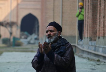 Téléchargez les photos : 12 janvier 2024, Srinagar Cachemire, Inde : Un homme prie à la Jamia Masjid ou Grande Mosquée de Srinagar. Des prières spéciales de congrégation connues sous le nom de "Salatul Istisqa" ont été organisées par Anjuman Aquaf Jamia Masjid pour le répit du temps sec dominant - en image libre de droit
