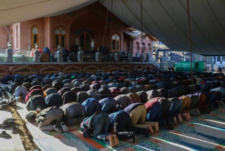 Photo for March 19,2024, Srinagar, India :  Kashmiri Muslims offer prayer outside  a mosque during holy month of Ramadan - Royalty Free Image