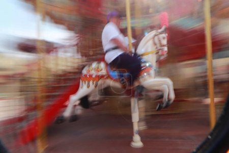 Photo for March 20, 2024 in Mexico City, Mexico: A woman enjoys spinning inside a carousel during the inauguration of the  the 'Aztlan' urban park, located in the second section of the Chapultepec forest - Royalty Free Image