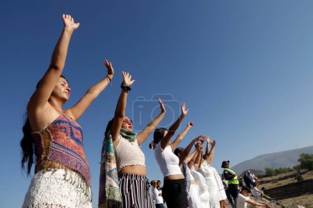 Téléchargez les photos : 21 mars 2024, État de Mexico, Mexique : Une femme lève la main pour se remplir d'énergie pendant l'équinoxe de printemps dans la zone archéologique de Teotihuacan dans la municipalité de Teotihuacan - en image libre de droit