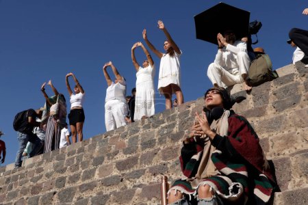 Photo for March 21, 2024, State of Mexico, Mexico: Persons  raise their  hands to fill herself with energy during the spring equinox in the archaeological zone of Teotihuacan in the Municipality of Teotihuacan - Royalty Free Image
