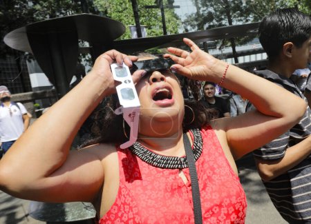 Photo for April 9, 2024, Mexico City, Mexico: People from Mexico City gathered in the vicinity of the Angel of Independence, to be able to observe the partial eclipse of the sun, they used special lenses - Royalty Free Image