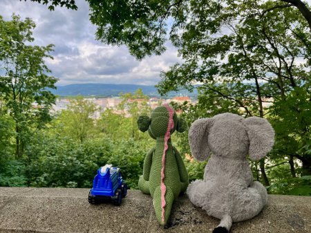 Photo for Toys look at the panorama of the city Teplice Ustecky region from park Letna. High-quality photo. Elephant, Dinosaurus and a blue police car. - Royalty Free Image