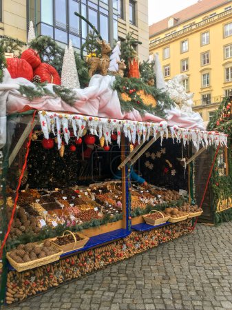 Photo for DRESDEN, GERMANY - 27.11.2018: A Christmas stall at a fair in Dresden. Selling nuts and dried fruits. High quality photo - Royalty Free Image