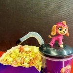 Cute toy Skye of Paw Patrol. Set of bucket popcorn and soft drink to promote the movie PAW Patrol: The Mighty Movie. High quality photo