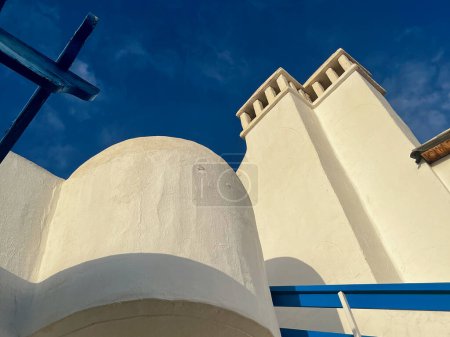 Traditional white buildings and hotels in with blue skies and ocean. High quality photo