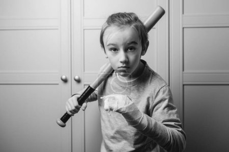 Téléchargez les photos : Teenager with broken arm. Boy holding baseball bat. Kid with broken hand after training. Sport time and healthcare. Health, lifestyle and sport concept. - en image libre de droit
