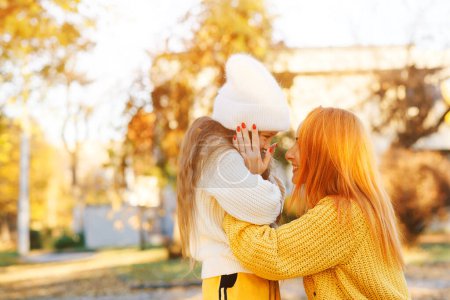 Photo for Lovely girl with her mom hugging on autumn walk. Autumn holidays, lifestyle. Happy family playing in the autumn park. - Royalty Free Image