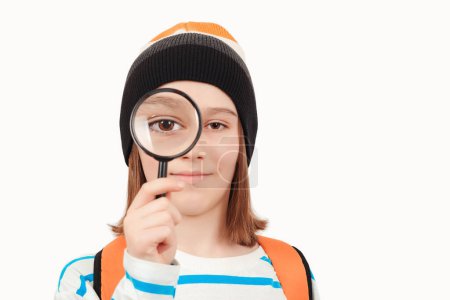Photo for Boy looking through magnifying glass. Schoolboy holding the magnifying glass. Children's interest. Portrait of student boy with magnifier. School, learning and development concept. - Royalty Free Image