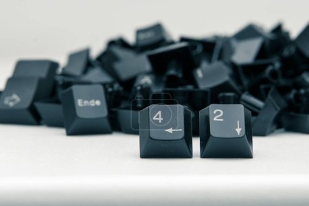 Photo for From a pile of black keyboard keys, two number keys stand out: "42". - Royalty Free Image