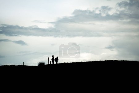 Photo for A couple tries to find their way on a hike - Royalty Free Image