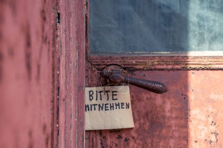 Photo for There is a sign on an old door that says "PLEASE TAKE". - Royalty Free Image