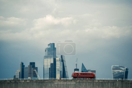 Photo for A red double-decker bus on Waterloo Bridge in London with skyscrapers in the background - Royalty Free Image
