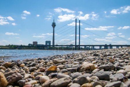 Photo for The Duesseldorf skyline on a beach near the Rhine on a sunny summers day - Royalty Free Image
