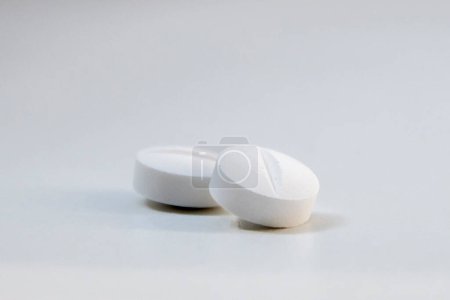 Photo for Two pain pills on a light table - Royalty Free Image
