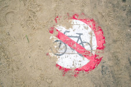 Photo for Bicycles prohibited on the beach: Prohibition sign lies in the sand - Royalty Free Image