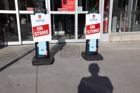 Photo for Toronto Ontario Canada  Metro grocery chain store front on strike with Unifor union flag outside the front entrance - Royalty Free Image