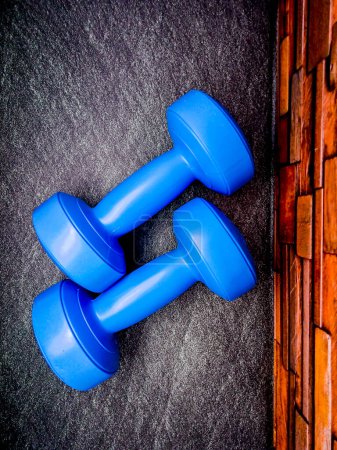 Photo for Blue colour 1kg Gym Dumble for fitness on the floor. - Royalty Free Image