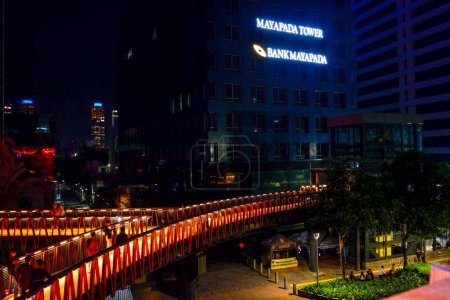 Photo for Jakarta, Indonesia - March 3, 2023: Night view long exposure of Pinisi Karet Sudirman pedestrian bridge over busy street traffic in Jakarta city - Royalty Free Image
