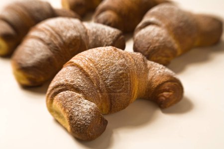 Photo for Baked Croissants with Sugar Icing, Close-Up Macro with Blurred Background  Processed Breakfast Food for Oven, Ready to Eat, Traditional French Bakery Cuisine, Sweet Bun with Butter, Pastry Detail - Royalty Free Image
