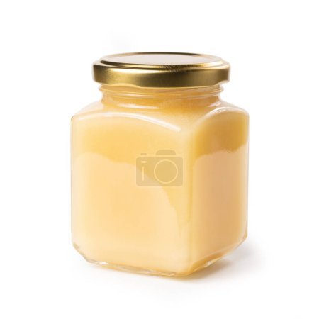 Photo for Honey Jar - Square, Cube Glass Victorian Jar with Golden Lid - White Light Honey - Macro Close Up on Foam - Isolated on White Background - Royalty Free Image