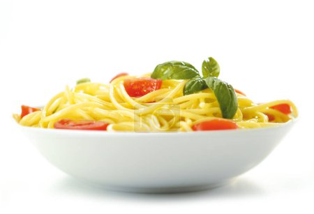 Photo for Spaghetti Plate, Isolated on White Background  Original Italian Pasta without Sauce, with Basil Leaves and Cherry Tomatoes ("Pomodoro Ciliegino" or "Pomodorini")  High Resolution Close-Up Macro - Royalty Free Image