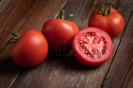 Photo for Tomatoes, detailed close-up macro, high resolution  Bunch, Group of Fresh Italian Tomatoes, Red Vegetable, Green Stem, Traditional Cuisine Ingredient on Wooden Table - Royalty Free Image
