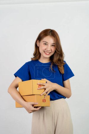 Photo for Beautiful Asian woman holding box isolated on white background Concept copy space of online sales and parcel delivery. - Royalty Free Image