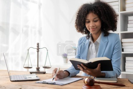 Photo for Court proceedings, African female judge smiling neutrally looking at camera wise justice incorruptible And Fair does her job professionally. sentencing criminals and protecting the innocent - Royalty Free Image