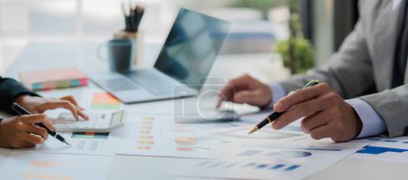 Photo for Longitudinal montage on a conference room table in a business presentation or seminar. Documents include financial or marketing figures, graphs, and charts. There is a laptop and a close-up. - Royalty Free Image