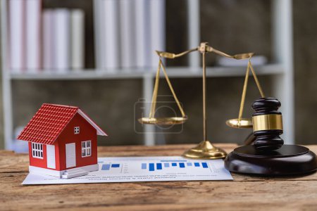 Photo for Real Estate Law Concepts Judge hammer and house model on the table, golden hammer and scales, small house - Royalty Free Image