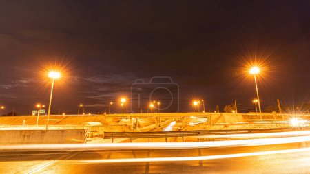 Photo for Time movement of fast night driving in a big city from the car window in front to the road with light lines from vehicles and street lights. - Royalty Free Image