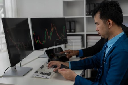 Photo for Forex traders Man in front of multiple computer monitors Automated computer monitor of business processes from financial stock analysis data graphs. - Royalty Free Image