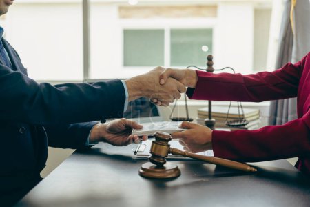 Photo for Businessman shaking hands thankfully closing a deal with his lawyer to discuss contract terms Good cooperation in counseling between lawyers, close-up photo - Royalty Free Image