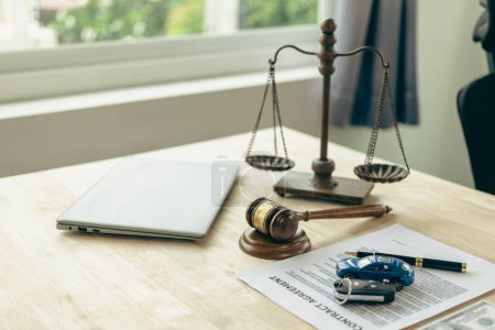 Photo for Lawyer, judge's gavel and miniature car as symbols of auction or court action against driver who got into an accident and received car insurance money on the table. Close-up view. - Royalty Free Image