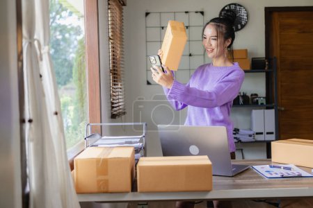 Photo for Small business owner, Asian woman working at home office Retail market, business and sales, online marketing, SME e-commerce concept, starting a small business Laptop Marketing Review, Packaging, - Royalty Free Image