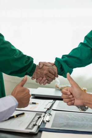 Photo for Medical team or doctor holding hands in interview Good job or successful promotion at the meeting Congratulations hospital or medical personnel, close-up image - Royalty Free Image