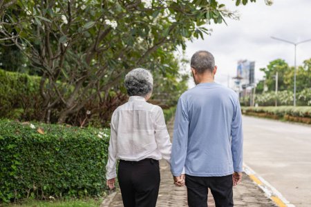 Photo for Couple in the park near home to relax, health and exercise in love sports, old man and senior woman taking a walk outdoors together in the morning - Royalty Free Image