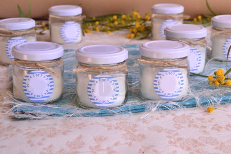 Photo for Wedding favors nautical sailor style decoration jar candles blue white colors jute ribbon, summer beach weddings ideas, baby boy shower baptism first communion souvenirs - Royalty Free Image