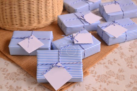 Photo for Guest favors small gifts baby boy shower first communion baptism souvenirs, nautical sailor style soaps packaging blue white striped paper ribbon, summer beach weddings presents decoration ideas - Royalty Free Image