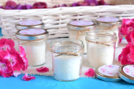 Photo for Wedding favors candles glass jars jute ribbon small guest gifts white blue background pink flowers colorfull spring summer cheerful style weddings party souvenirs, decoration ceremony ideas - Royalty Free Image
