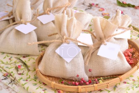 Photo for Wedding favors details decoration white jute burlap bags package for guest gifts, original party souvenirs rustic shabby chic style reception, diy handmade ideas for small presents - Royalty Free Image
