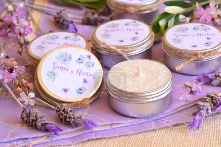 Photo for Wedding gifts personalized guest favors lavender scented tin candles handmade party souvenirs with custom labels in white and purple color floral design and bride groom names, rustic style decoration - Royalty Free Image