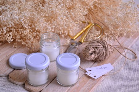 Wedding favors candle making small home business, sell online artisan diy handmade products, original event souvenir ideas, homemade products for gift, white glass jar candles wood jute ribbon background, prifitable crafting activity