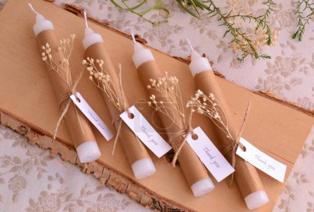 Photo for Wedding favors white candles decoration brown beige craft paper with jute ribbon dry flowers baptism baby, first communion guest gifts, rustic style, affordable cheap diy souvenirs, low cost concept, nature color palette - Royalty Free Image